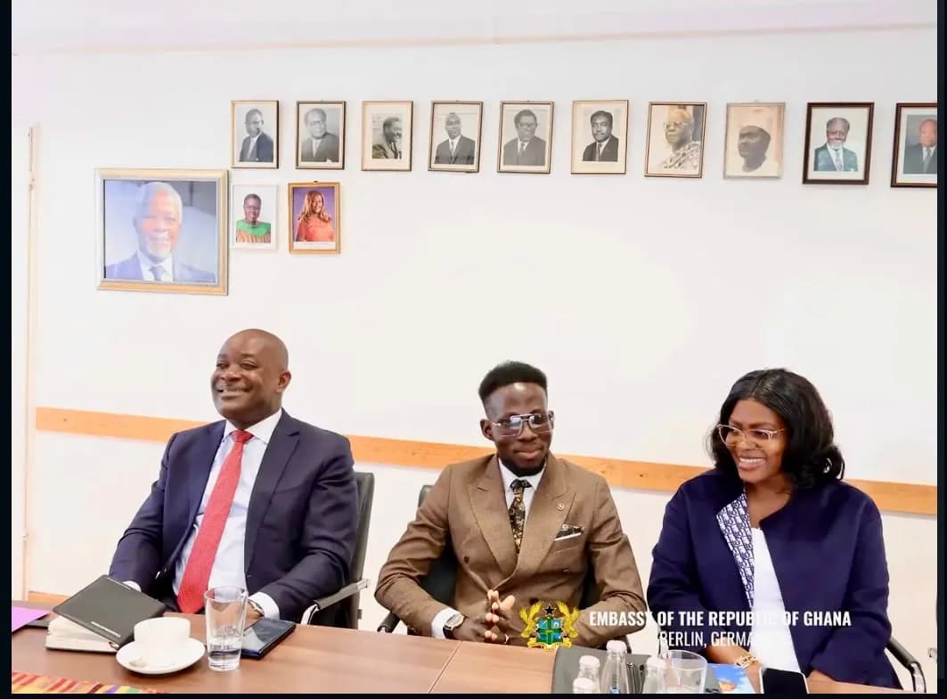 Three participants seated together at the meeting table.